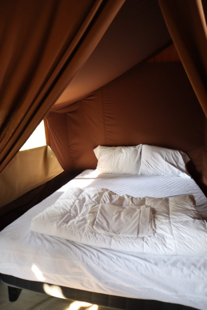 The Queen Bed In The Trappeur Tent at Huttopia Adirondacks